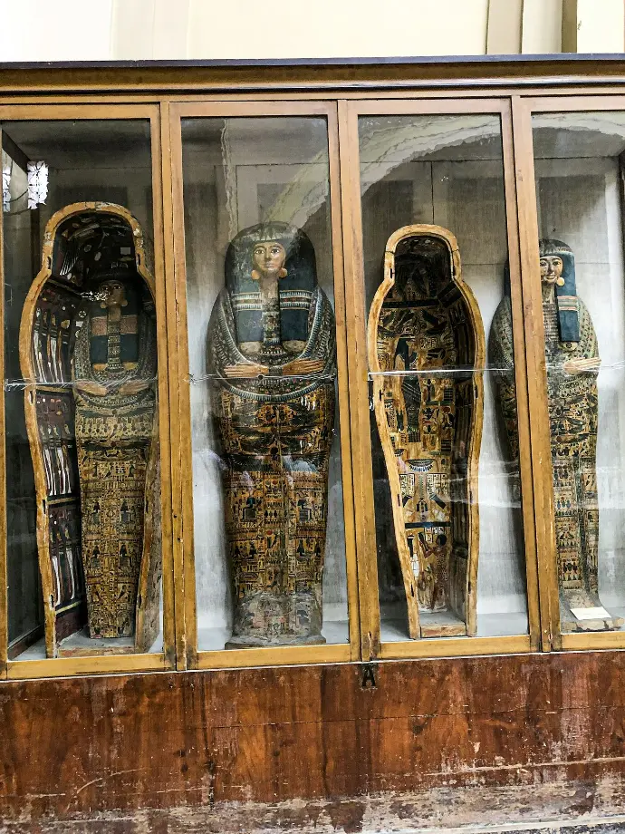 a group of carved wooden figures in a display case